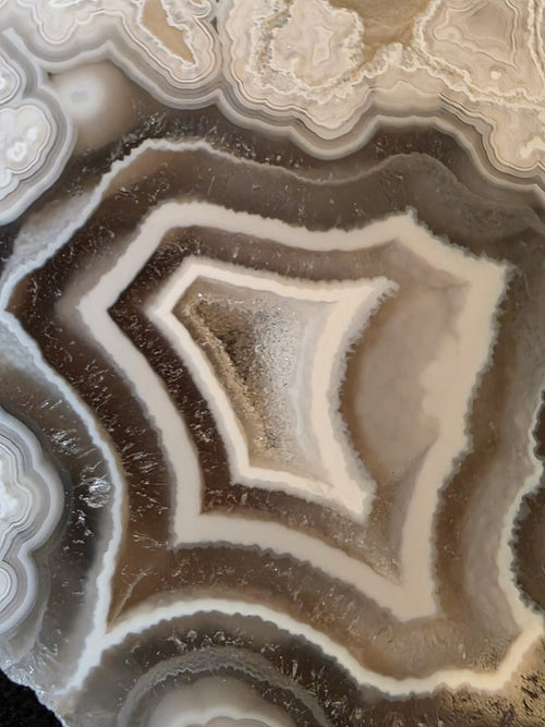Druzy crystalline interior of Lebanese polyhedral agate geode №001 from Minieh shore, North Lebanon, showing natural quartz crystal formations inside the chamber.
